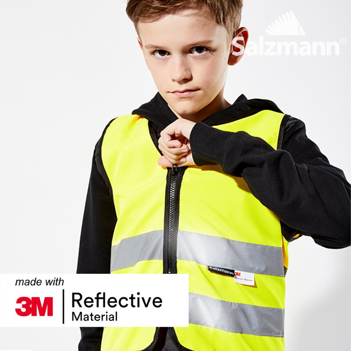 Boy zipping up a Yellow high vis safety vest