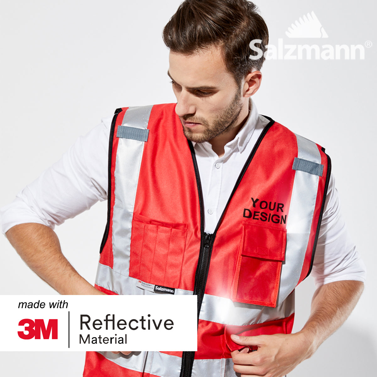 Close up of man stood looking down wearing a Red safety vest