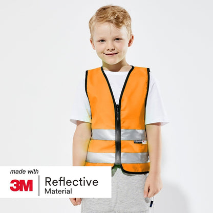Boy stood smiling wearing a Orange high visibility safety vest