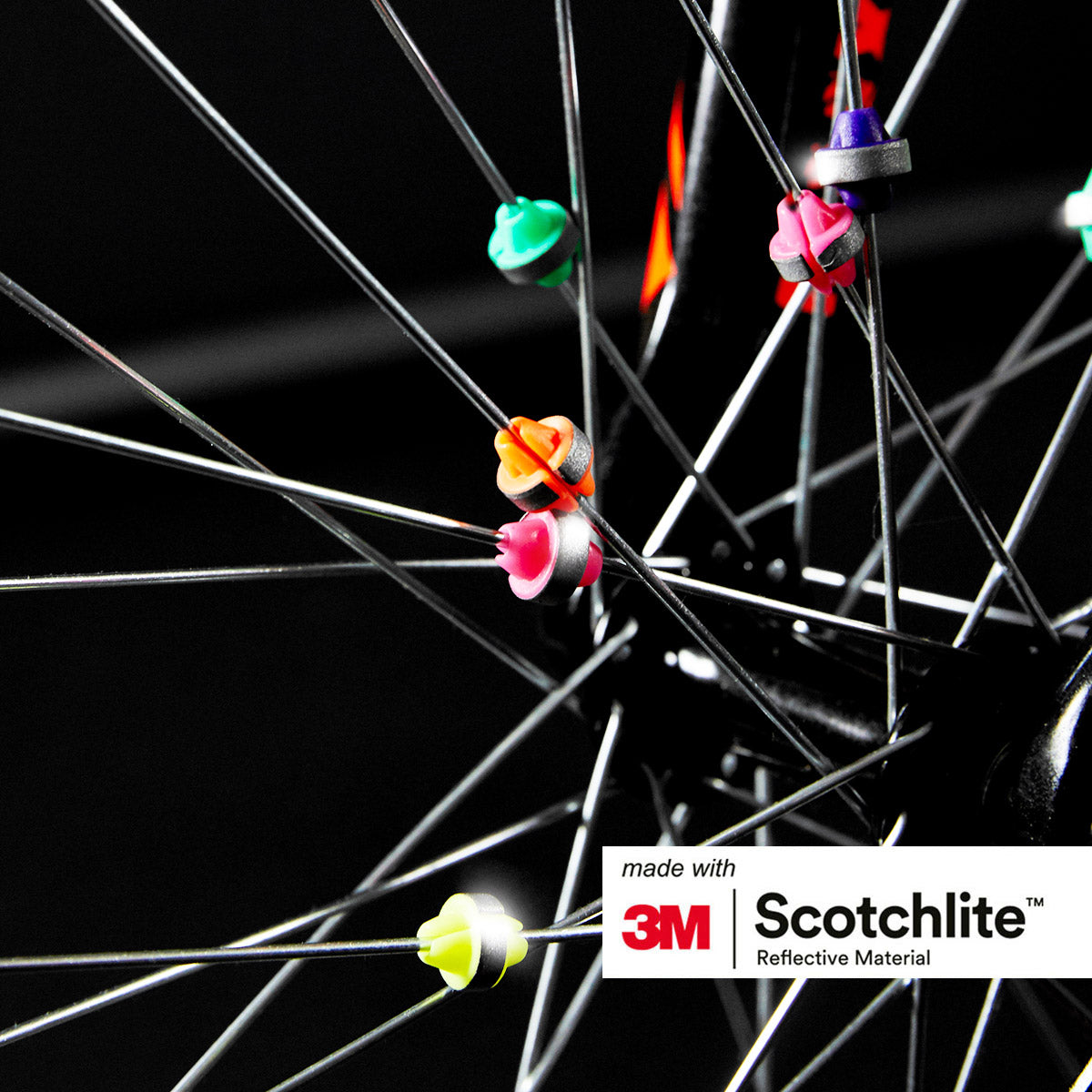 Close up of bike wheel spokes with different colored spoke beads on.