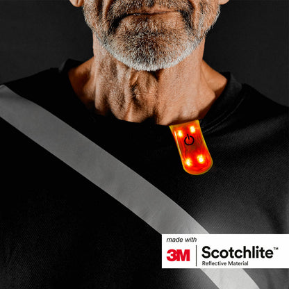 Close-up of persons collar wearing the magnetic clip with 4 red LED lights turned on.