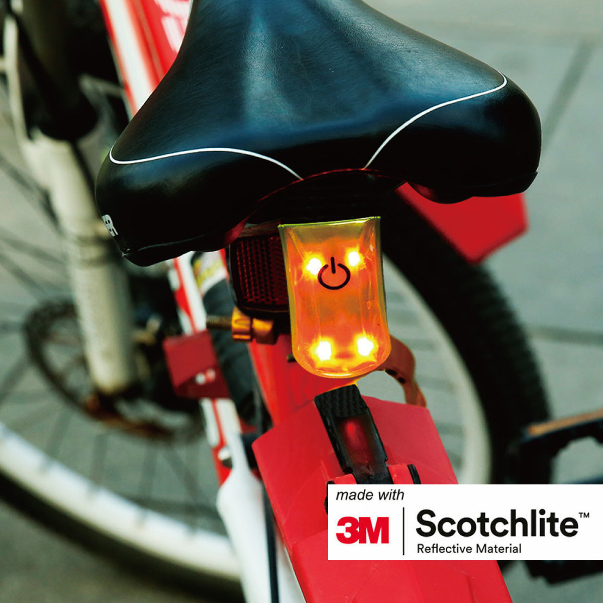 Back of bicycle seat with LED reflective clip attached.