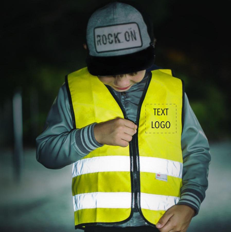 Boy stood zipping up a Yellow safety vest with "Text/Logo" on the front