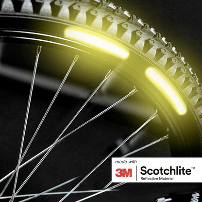 Close up of a bicycle wheel with 2 hi vis yellow stickers on the rim.