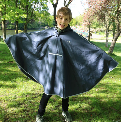 Child stood outside wearing the Navy poncho.